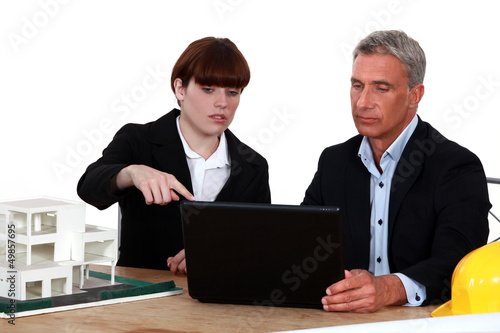 Photo: Architects with a laptop and 3D model Architects with a laptop and 3D model