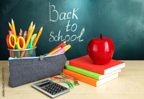 Photo: Back to school - blackboard with pencil-box and school Back to school - blackboard with pencil-box and school