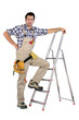 Handyman stood by step-ladder