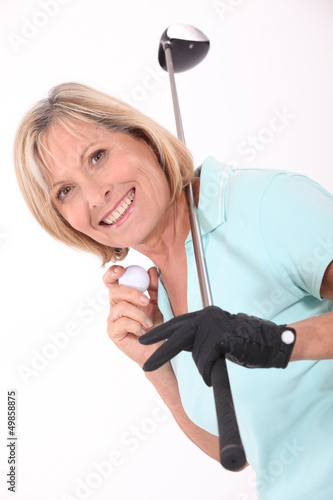 Photo: senior woman playing golf senior woman playing golf