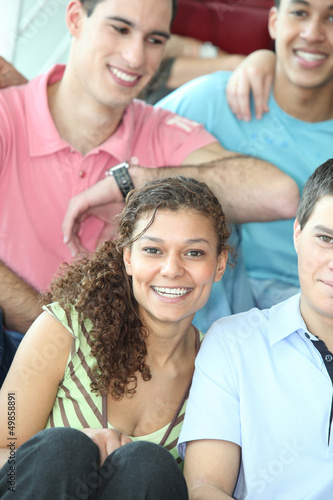 Photo: Group of teenage friends sat together Group of teenage friends sat together