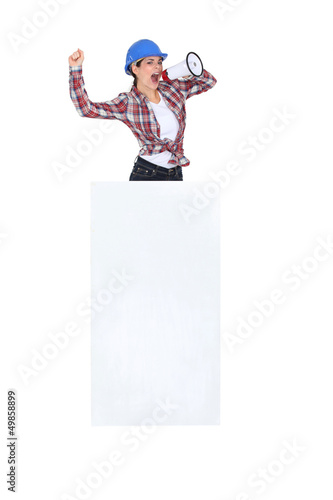 Photo: Construction worker with a loudhailer. Construction worker with a loudhailer.