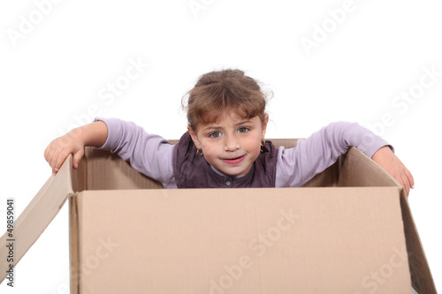 Photo: little girl hiding in a box little girl hiding in a box