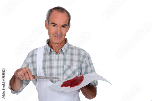 Photo: butcher cutting fresh meat butcher cutting fresh meat