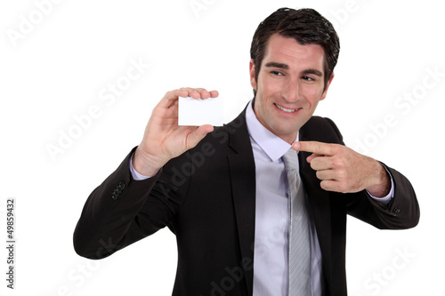 Photo: Man pointing at business card Man pointing at business card