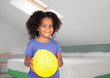 Photo: Adorable african little girl with a yellow balloon Adorable african little girl with a yellow balloon