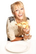 Girl hols piece of pizza and laugh