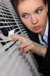 businesswoman looking through the blinds