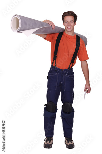 Photo: Man with a roll of linoleum Man with a roll of linoleum