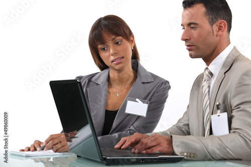 Photo: Two business visitors working with laptop Two business visitors working with laptop