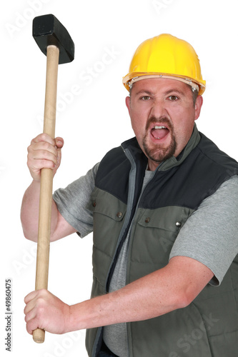 Photo: An angry tradesman holding a mallet An angry tradesman holding a mallet