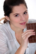 Young woman with a huge bar of chocolate