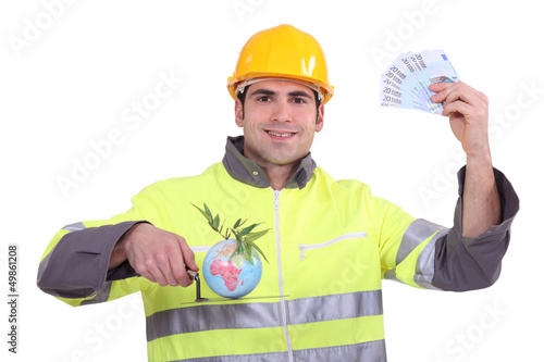 Photo: Builder with a globe and cash Builder with a globe and cash