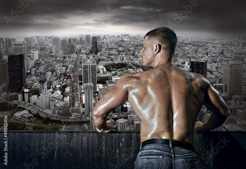 Photo: Man stay on the roof of skyscraper Man stay on the roof of skyscraper