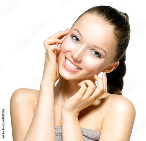 Photo: Beautiful Young Woman with Fresh Clean Skin touching her Face Beautiful Young Woman with Fresh Clean Skin touching her Face