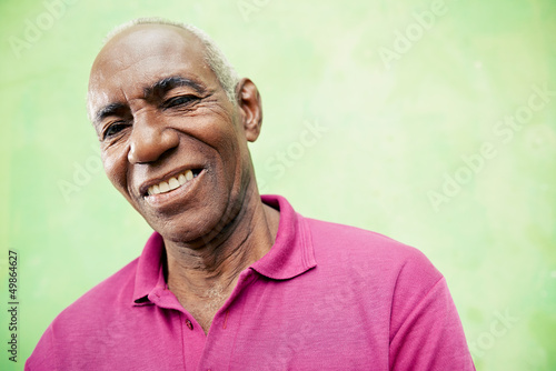 Photo: Portrait of elderly black man looking and smiling at camera Portrait of elderly black man looking and smiling at camera