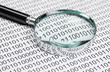 magnifying glass on a binary code