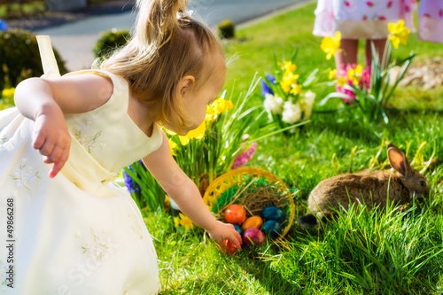 Photo: Children on Easter egg hunt with bunny Children on Easter egg hunt with bunny
