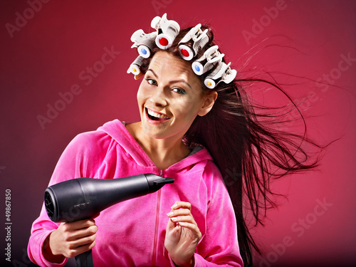 Photo: Woman wear hair curlers on head. Woman wear hair curlers on head.