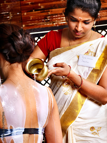 Photo: Woman having Ayurvedic spa treatment. Woman having Ayurvedic spa treatment.