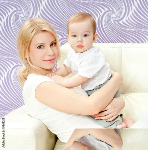 Photo: young mother with a charming baby young mother with a charming baby