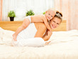 Mother and daughter play in the bedroom