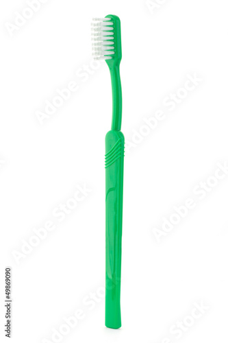 Photo: Single green toothbrush on white Single green toothbrush on white