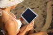 woman at the beach with tablet-pc