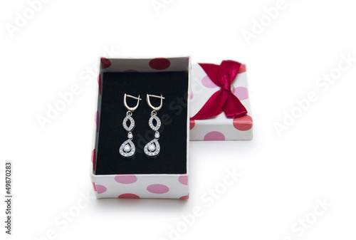Photo: Silver earrings in a box isolated on white background Silver earrings in a box isolated on white background