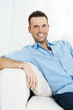 Portrait of smiling man on the sofa