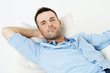 Handsome man relaxing with hand behind head