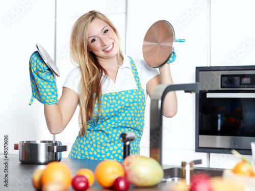 Photo: Happy baking cooking woman in her kitchen Happy baking cooking woman in her kitchen