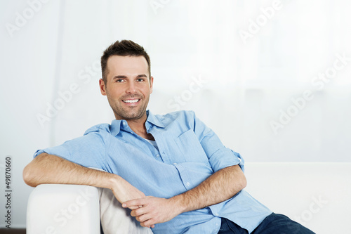 Photo: Man relaxing on sofa. Man relaxing on sofa.