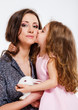 Girl kissing her mom