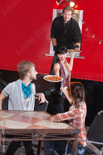 Photo: Friends Get Hot Pizza from Truck Friends Get Hot Pizza from Truck