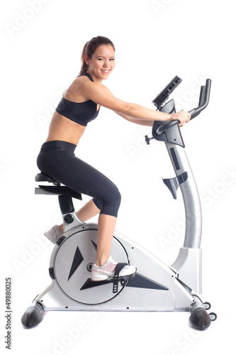Photo: Brunette woman on bike exerciser Brunette woman on bike exerciser