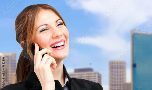 Photo: Young woman talking on the phone outdoor Young woman talking on the phone outdoor