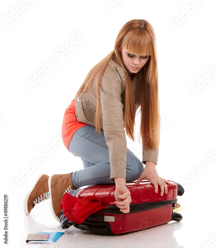 Photo: young girl with suitcase on white young girl with suitcase on white