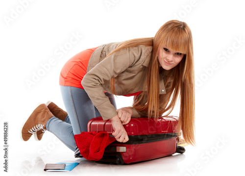 Photo: young girl with suitcase on white young girl with suitcase on white