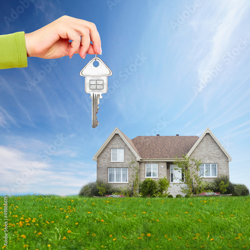 Photo: Hand with a house key. Hand with a house key.