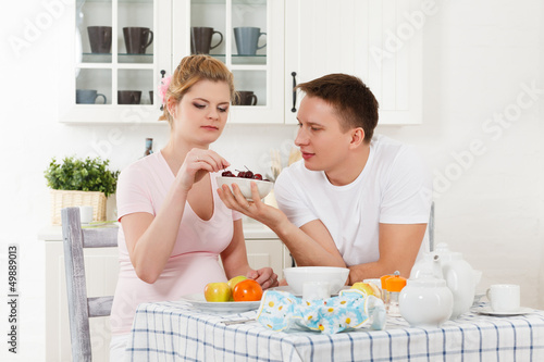 Photo: Happy pregnant family and healthy food Happy pregnant family and healthy food