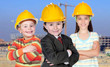 Three future workers with a building construction