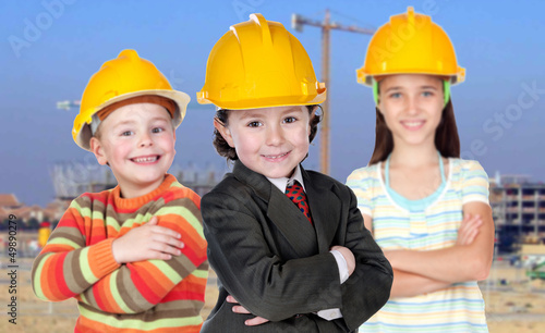 Photo: Three future workers with a building construction Three future workers with a building construction