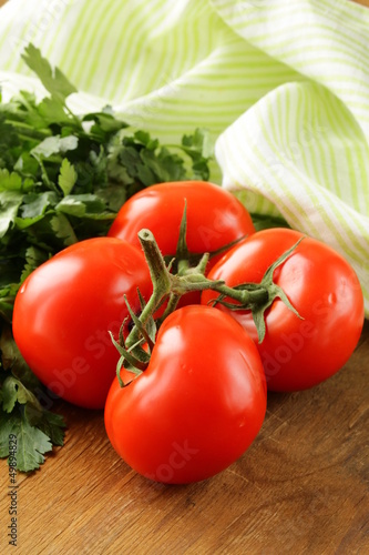 Photo: ripe organic tomatoes on a wooden table ripe organic tomatoes on a wooden table