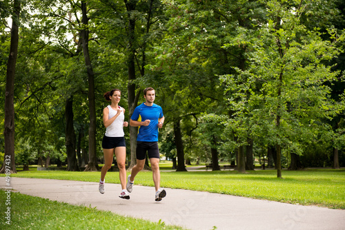 Photo: Jogging together - young couple running Jogging together - young couple running