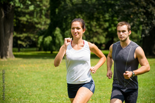 Photo: Jogging together - young couple competing Jogging together - young couple competing