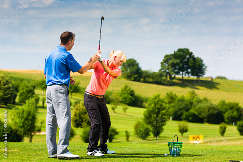 Photo: Young female golf player on course Young female golf player on course