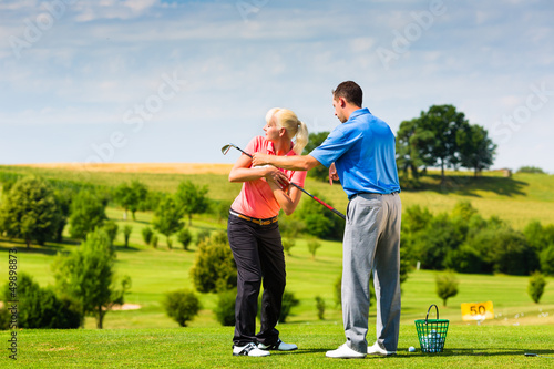 Photo: Young female golf player on course Young female golf player on course