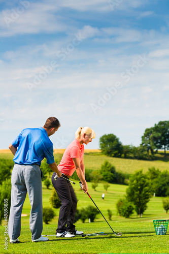 Photo: Young female golf player on course Young female golf player on course