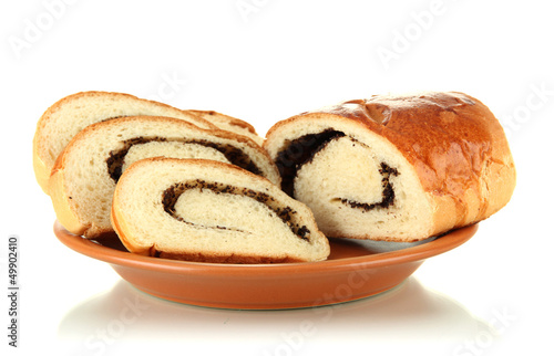 Photo: Loaf with poppy seeds on color plate, isolated on white Loaf with poppy seeds on color plate, isolated on white